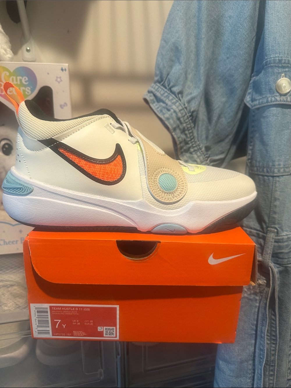 Nike Kids White Sneakers with Orange Swoosh and Teal Accent